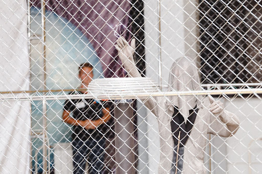 An electrician inspects a Faraday cage.